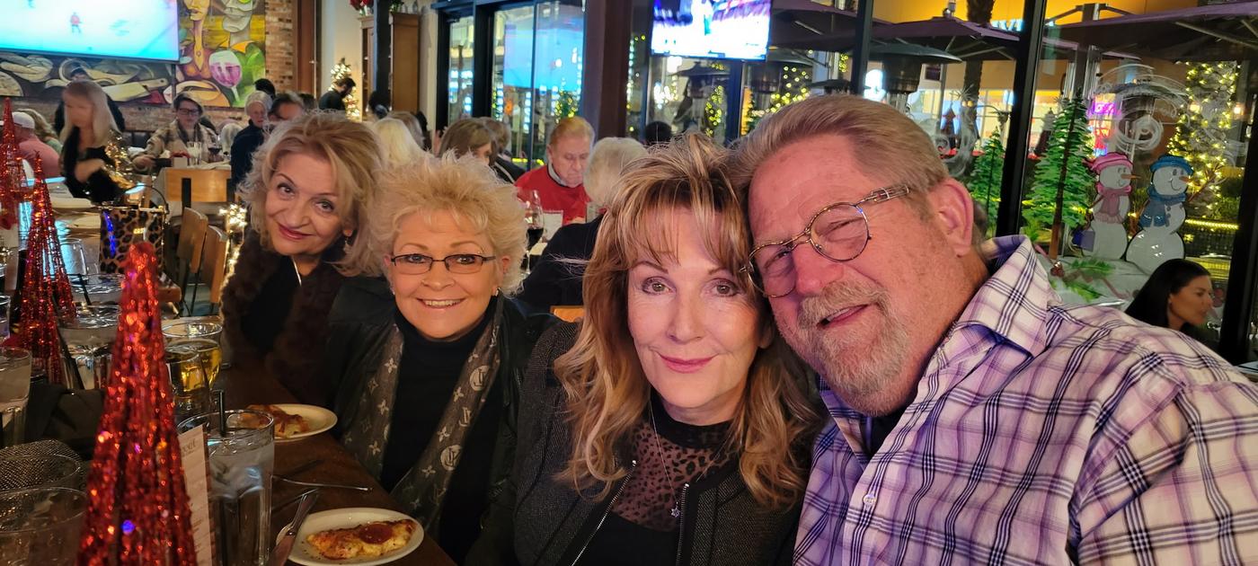 Craig smiling with a group of friends and fans at a lively Las Vegas venue