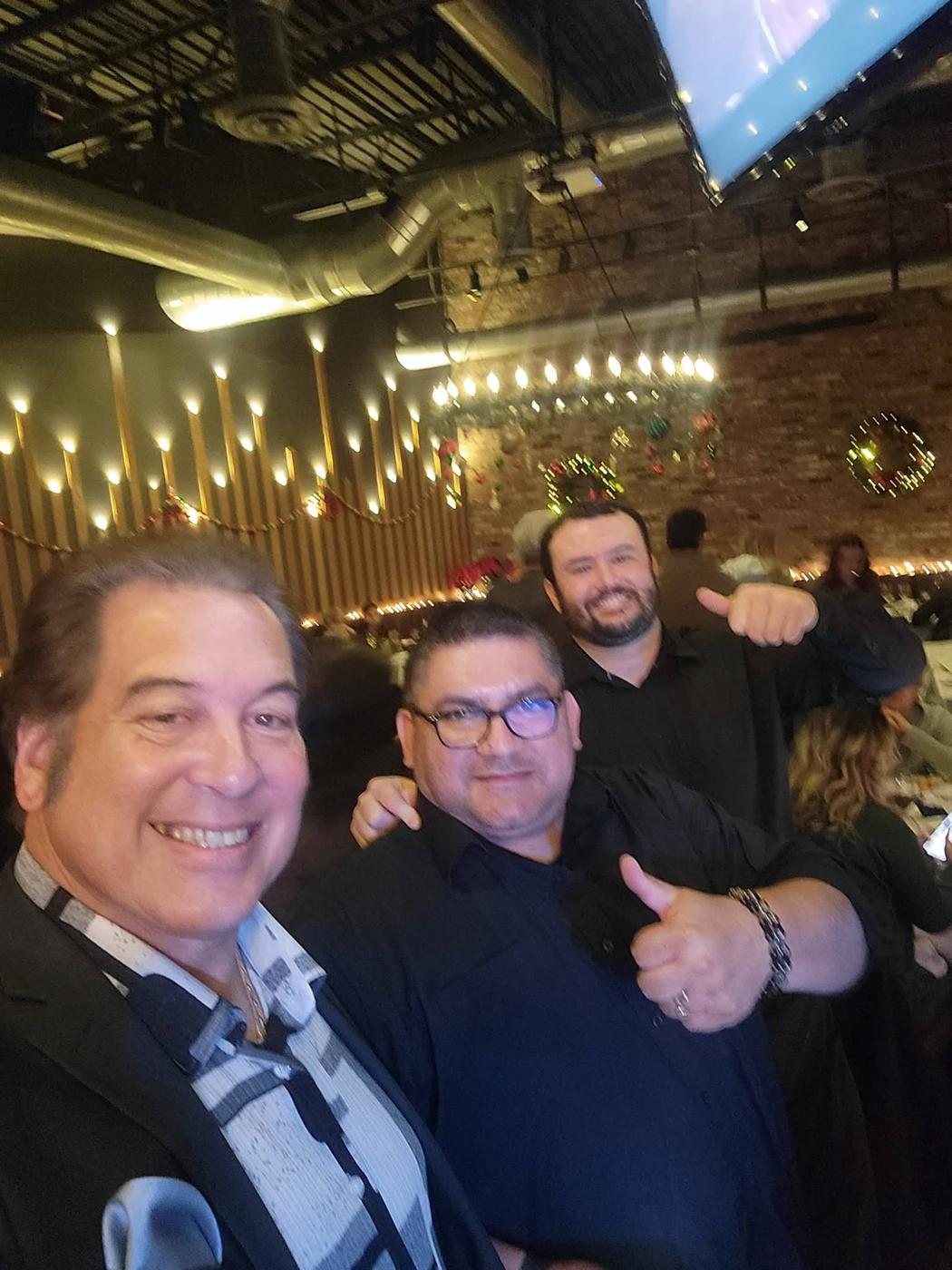 Craig taking a photo with friends in the audience